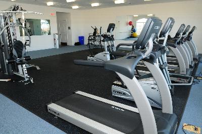 Photo of the Harbortown Breeze gym located in the community clubhouse, featuring cardio and strength training equipment.