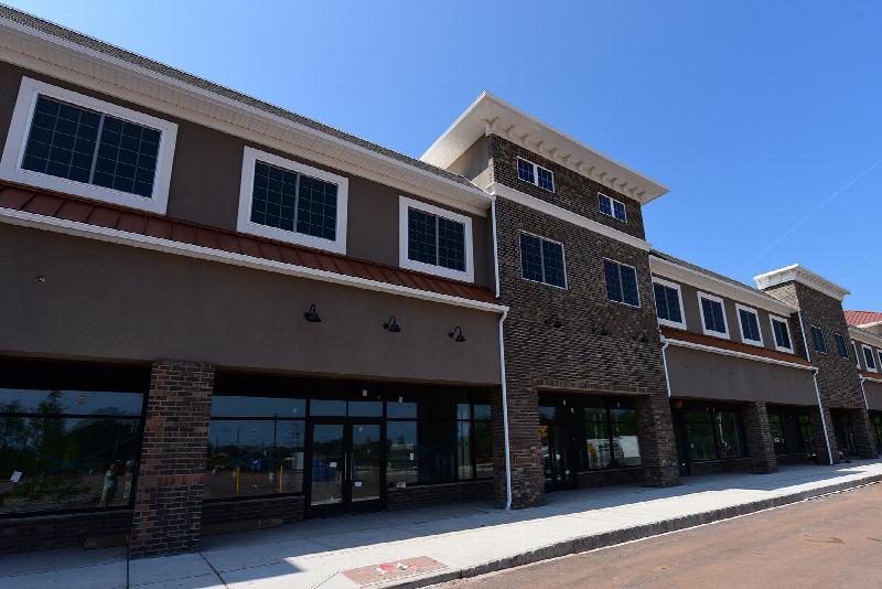 The Grove at Montgomery Exterior photo showing a brick exterior and several glass doors.