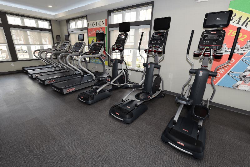Interior photo of the gym located in the Summit Club at Sun Valley showing multiple treadmills and elliptical machines.