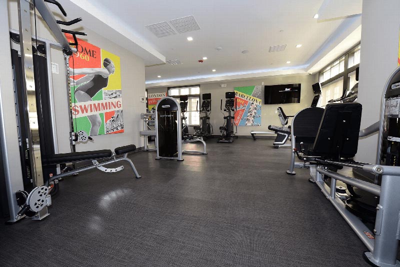 Interior photo of the gym located in the Summit Club at Sun Valley showing multiple pieces of strength training machines.