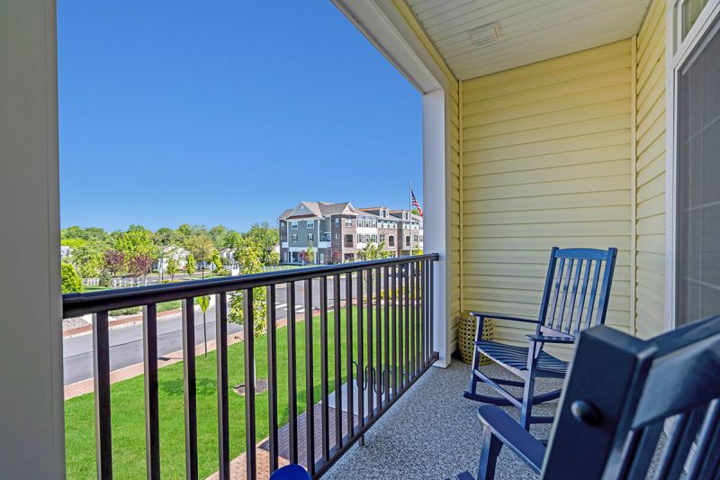 River Links photo of a typiical balcony showing two rocking chairs for relaxing and a view of the property.