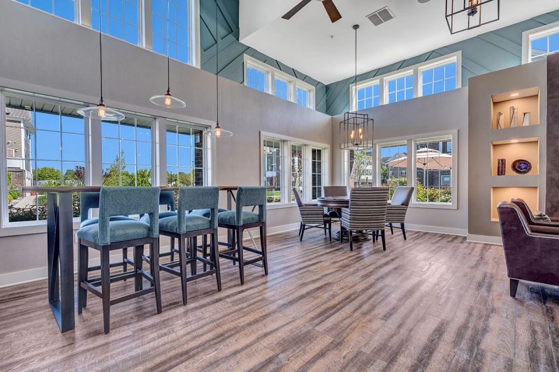 River links interior photo of the clubhouse main room, showing wood grain flooring and multiple seating areas.