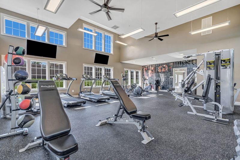 River Links interior photo of the gym, showing multiple pieces of gym equipment including treadmills, ellipticals and weight machines
