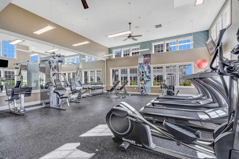 River Links interior photo of the gym, showing multiple pieces of gym equipment including treadmills, ellipticals and weight machines