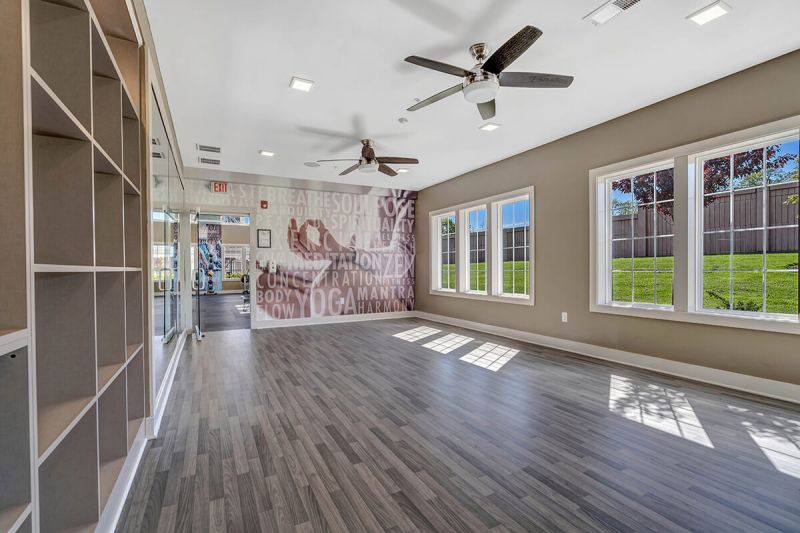 River Links interior photo of the yoga studio showing an open area, with several windows for natural light.