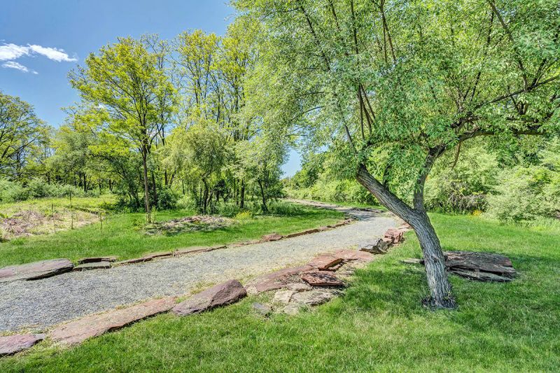 River Links exterior photo of part of the tree-lined walking path that is on the property for use by residents.