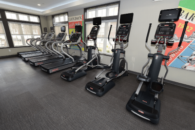 Interior photo of the gym located in the Summit Club at Sun Valley showing multiple treadmills and elliptical machines.