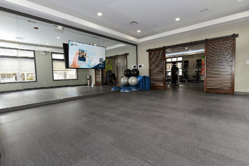 Photo of the movement studio located in the Summit Club at Sun Valley featuring a mirrored wall and a large wall mounted TV.