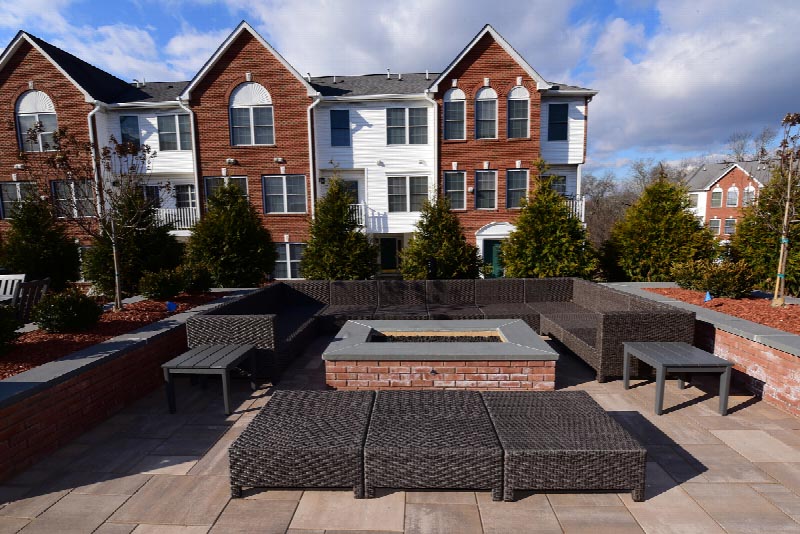 Exterior photo of the patio area at the Summit Club located at Sun Valley showing a large seating area surrounding an outdoor fire pit.