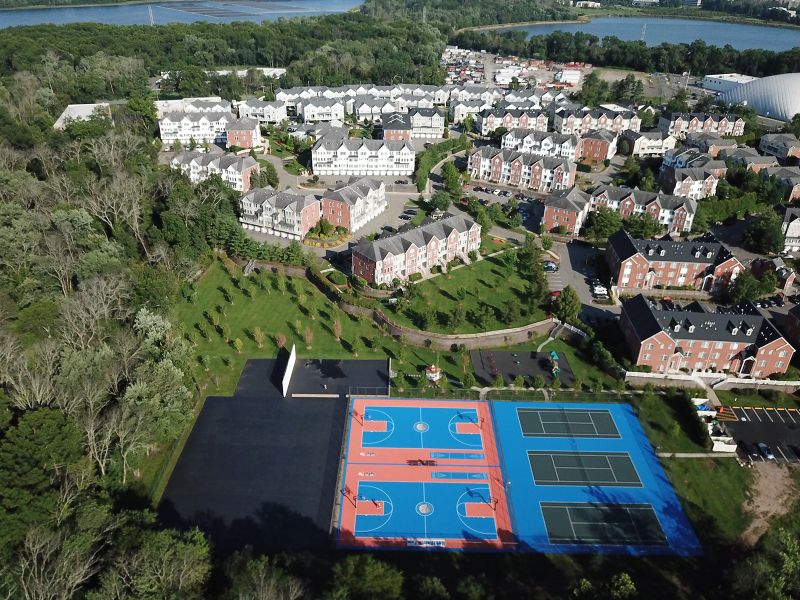 Aerial photo showing the Sun Valley Community, with the recreation area in the foreground with playground, gazebo, multiple tennis and basketball courts