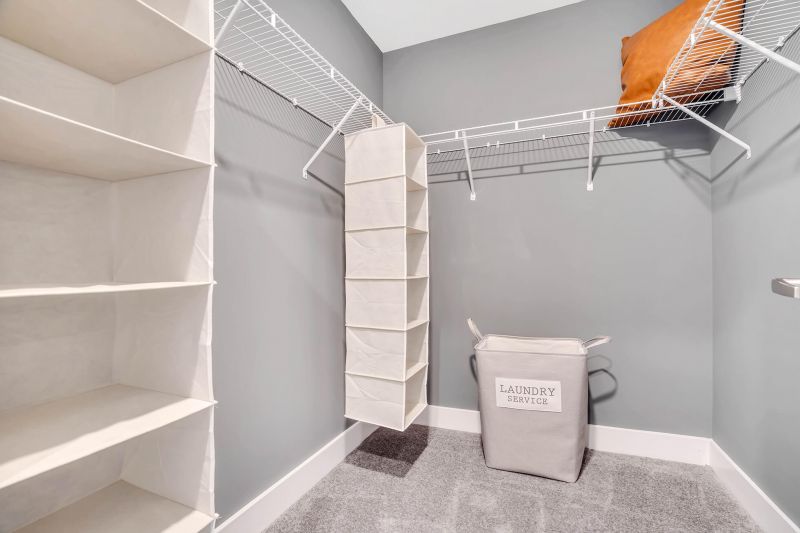 Interior photo of the walk in closet in the primary bedroom showing a spacious closet with wire frame shelving