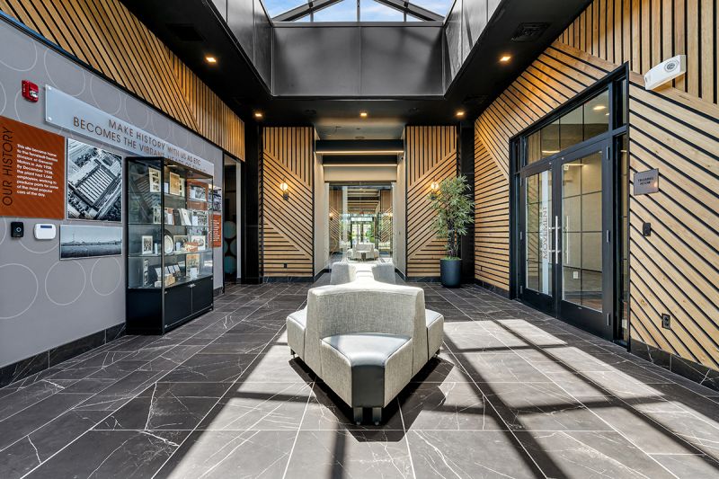 Interior photo of the lobby of the clubhouse at Ewing Town Center showing a dramatic atrium, marble flooring that leads down the center of the floor plan to access all areas of the clubhouse.