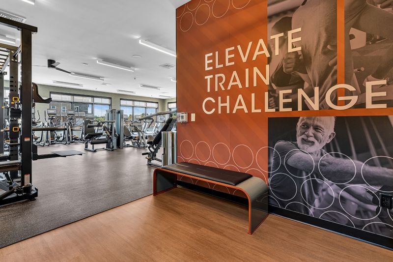 Interior photo of the community gym inside the clubhouse at Ewing Town Center showing multiple strength and cardio exercise machines.