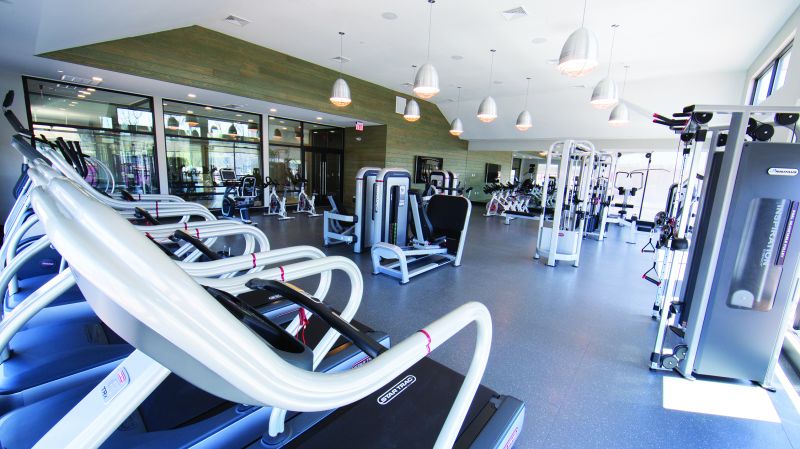 Grove Crossing gym photo showing several treadmills and exercise bikes and various other exercise equipment.