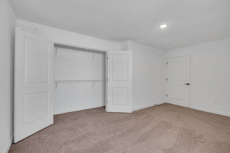 Interior photo of Amwell Terrace showing a bedroom with wall to wall carpeting and an oversized closet.