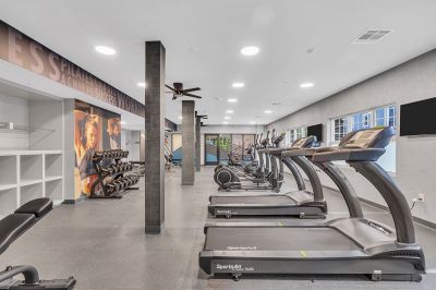 Interior photo of the community gym at Amwell Terrace showing various pieces of cardio equipment, free weights and a strength training machine