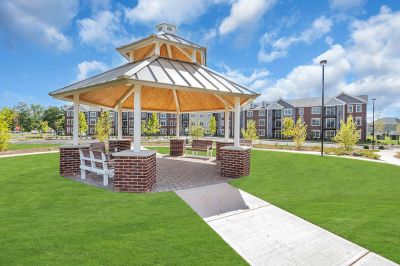 Exterior photo of Meadows at Montgomery showing the community gazebo with benches.