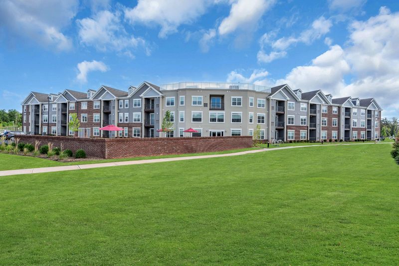 Exterior photo of Meadows at Montgomery showing the back of the community and the walking path.