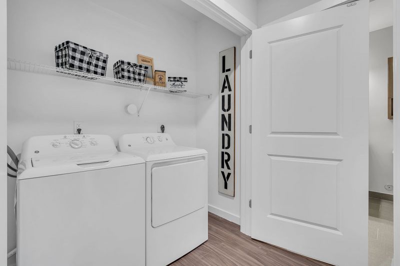 Interior photo of one of the community spaces at Meadows at Montgomery showing a luxury vinyl tile floor and multiple seating areas.