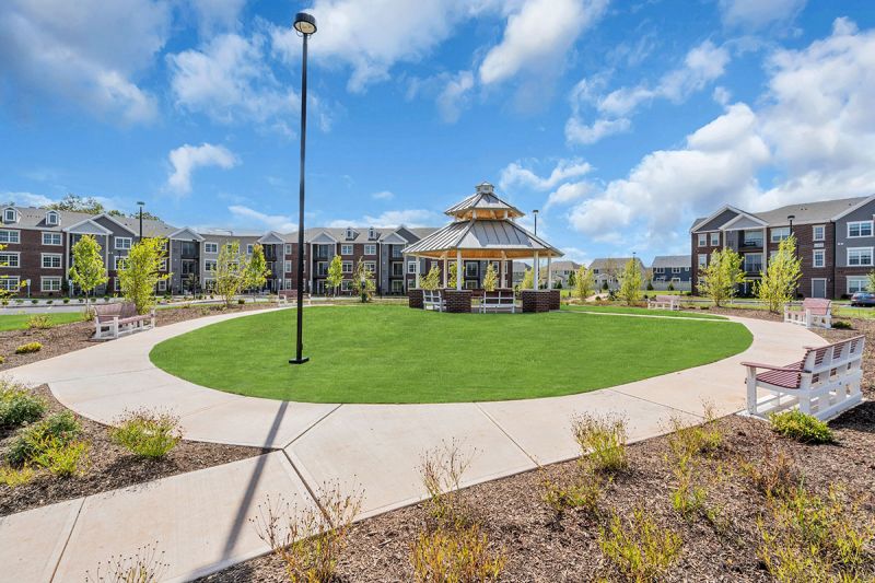 Exterior photo of Meadows at Montgomery showing the community gazebo with benches.