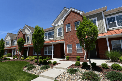 Gardens at Jackson Twenty One Exterior photo showing several patios and apartment entrances. Several bushes and trees highlight the landscape.
