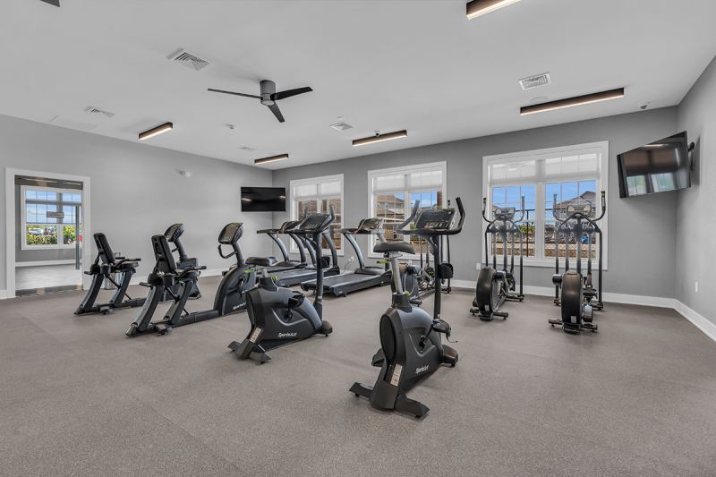 Photo of the cardio area at the gym in the clubhouse at Edison Lights featuring treadmills, ellipticals and bikes