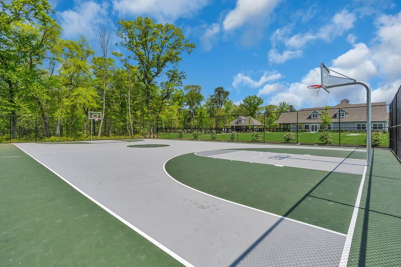Exterior photo of the basketball courts outside of the clubhouse at Woodhaven.