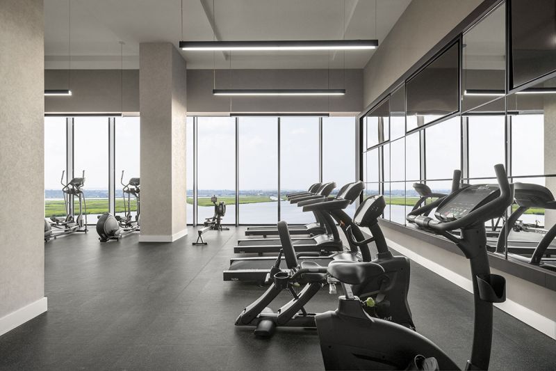 Interior photo of the gym at RVR showing ellipticals, rowing machine, multiple treadmills and stationary bikes