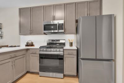Interior photo of the Boulders at Beekman showing luxury vinyl flooring, gray cabinets, white granite countertops and stainless steel appliances.