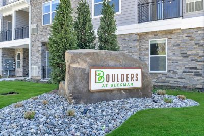 Boulder at Beekman sign, featuring the community logo placed on a large boulder outside one of the apartment buildings
