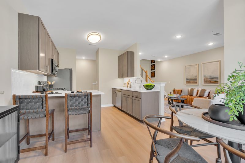 Interior photo of the Boulders at Beekman showing luxury vinyl flooring through out the downstairs, a fully equipped kitchen dining area and living room. Stairs to the second level can be seen off the living room.