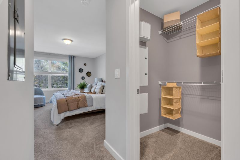 Interior photo of the Boulders at Beekman showing a walk in closet and a doorway leading to the primary bedroom