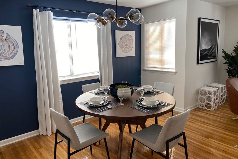 Edison Woods photo showing a dining room with hardwood floors and a large window for natural light.