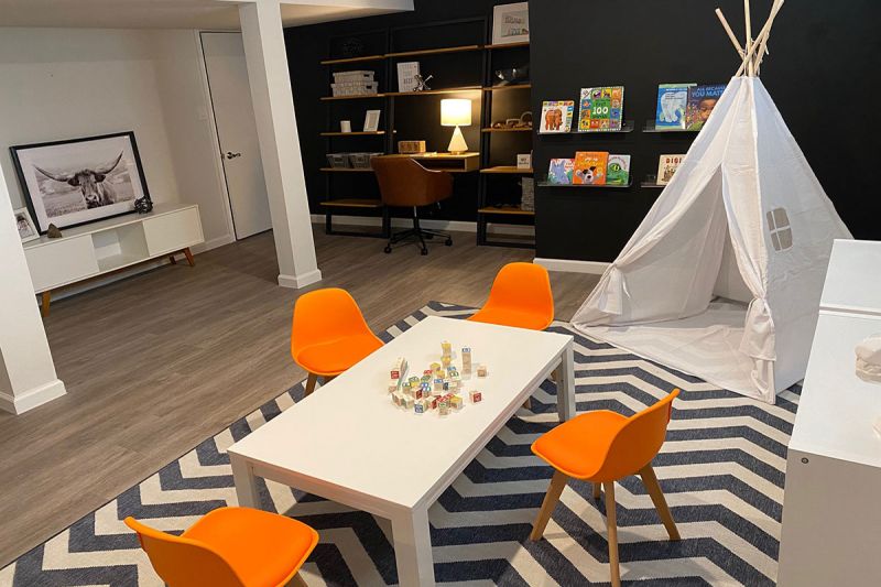 Edison Woods photo showing a finished basement area with luxury vinyl woodgrain flooring and a recreation area.