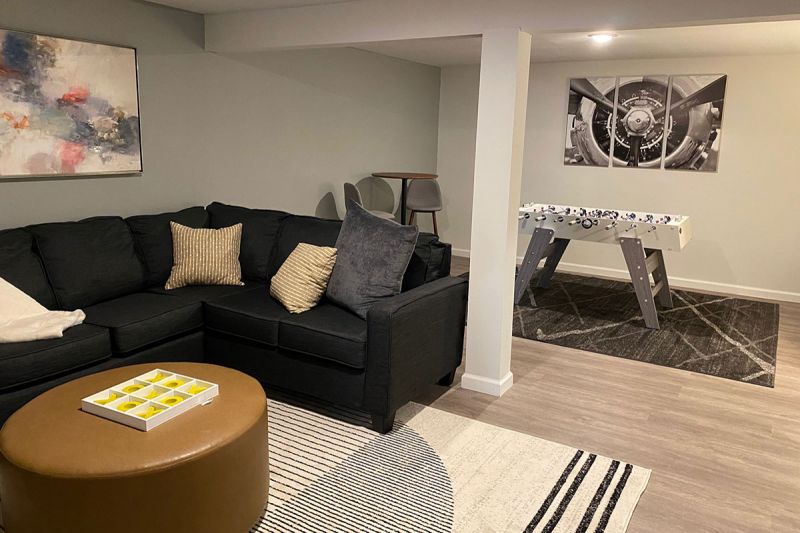 Edison Woods photo showing a finished basement area with luxury vinyl woodgrain flooring and a recreation area.