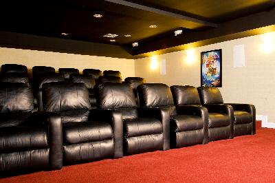Towne Centre at Englewood movie room photo showing black theater style seating with red carpeting and overhead lights.