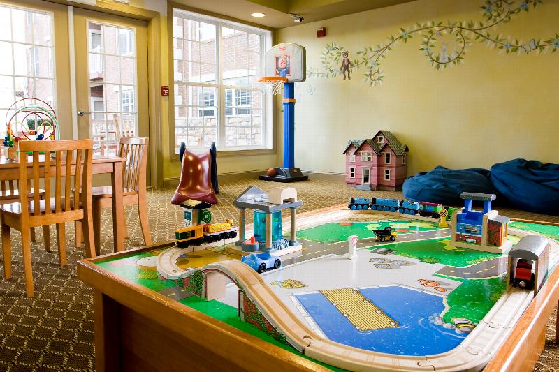 Towne Centre at Englewood photo of Childrens Play Area showing a play table, a doll house, a basketball net and other various toys.