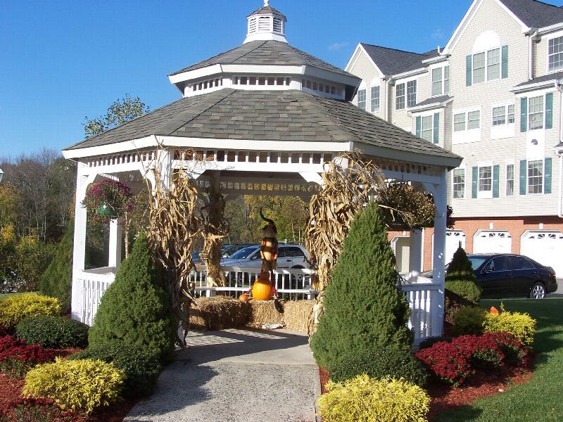 Photo of a gazebo located on the Sun Valley property decorated for the fall with pumpkins, hay and corn stalks.