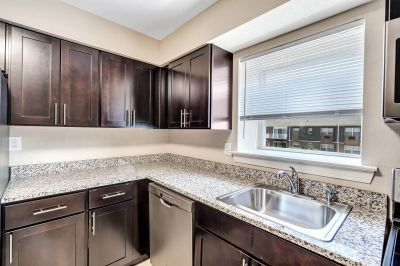 Interior photo of a refurbished kitchen at Beekman Gardens in Hillsborough, NJ showing fresh paint, new cabinets, granite countertops and stainless steel appliances.
