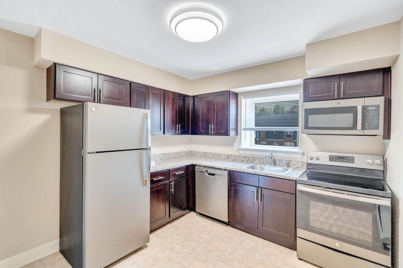 Interior photo of a refurbished kitchen at Beekman Gardens in Hillsborough, NJ showing fresh paint, new cabinets, granite countertops and stainless steel appliances.