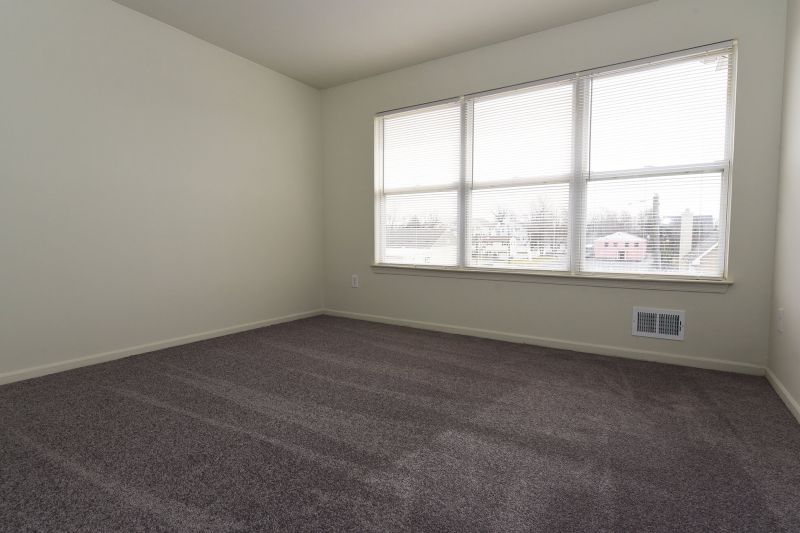 Photo of bedroom at Tyler Greens showing new carpeting, freshly painted walls and a double window to allow for fresh air and natural light
