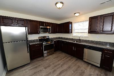 Yorkshire Meadows kitchen photo showing new cabinets, granite countertops, stainless steel appliances and wood grain flooring
