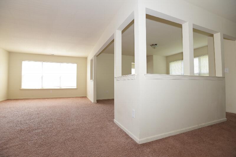 Homestead Village interior photo of the living area featuring new carpeting and freshly painted walls.