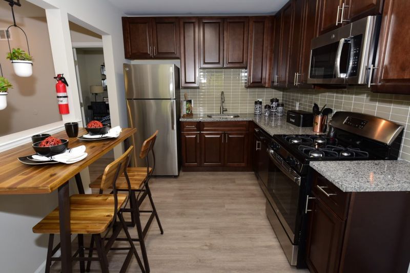 Maebrook at Renaissance interior photo of the kitchen showing wood plank flooring, new cherry cabinets with granite countertop and stainless steel appliances.