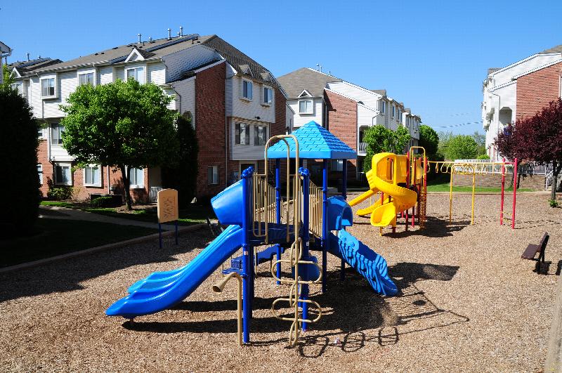 Harbortown Terrace exterior photo showing a playground with several pieces of play equipment including multiple slides.