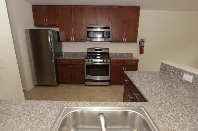 Harbortown Terrace Kitchen photo showing modern cabinets, granite countertops and stainless steel appliances.