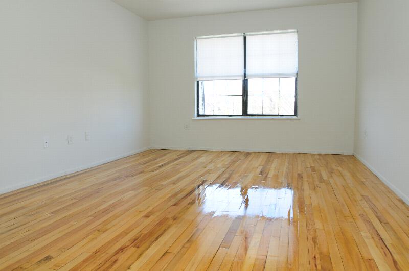 Hidden Village bedroom photo showing hardwood floor and a window that allows for natural light to fill the room.