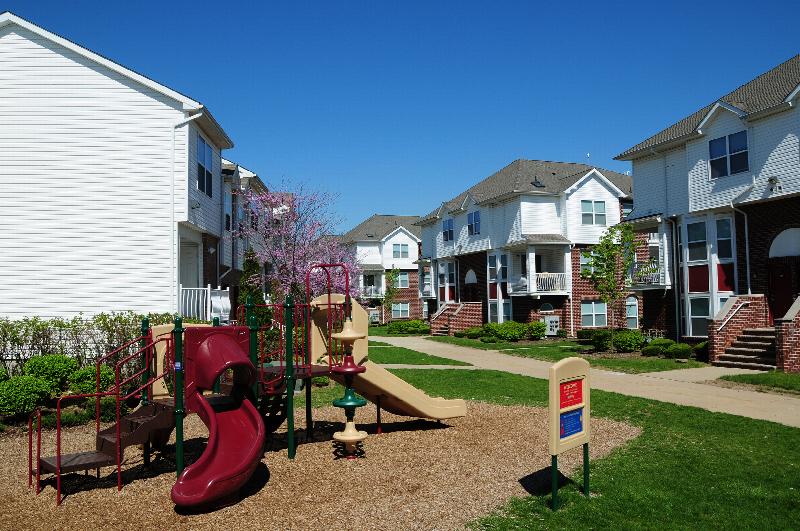 Photo of a one of the playgrounds at Harbortown, featuring a piece of equipment with stairs and multiple slides.