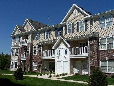 Willingboro Square building exterior photo showing several balconies and a street light. Several bushes highlight the landscaping.