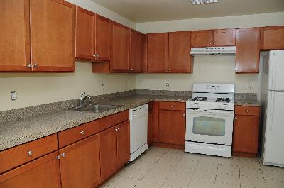 Willingboro Square kitchen photo shows maple color kitchen cabinets, white appliances and ceramic tile floor.